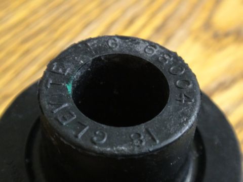 2000 Lincoln Continental - A black automotive part displays embossed lettering and numbers, indicating its manufacturer and possibly a date code.