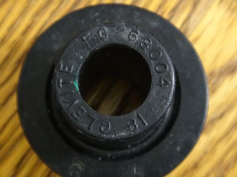 2000 Lincoln Continental - A close-up view of a black rubber bushing with embossed part numbers and manufacturer information.