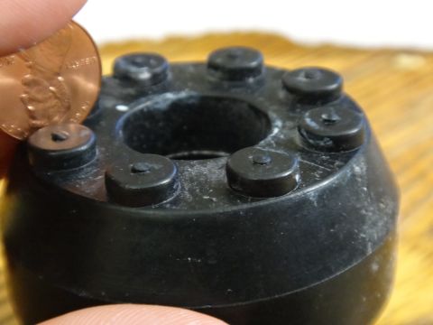 2000 Lincoln Continental - Close-up of a black rubber part with six studs, a penny is shown for scale.
