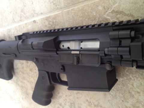 2013 Ford Mustang - Close-up view of an AR-15 style rifle receiver, showing internal components.