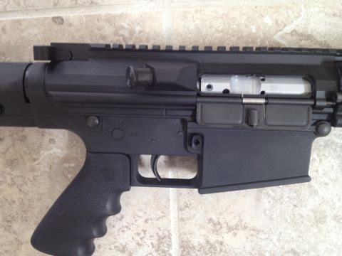 2013 Ford Mustang - The image shows the lower receiver of an AR-15 style rifle, with controls for safety and firing clearly visible.