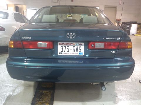 1998 Toyota Camry - The rear of a teal Toyota Camry is shown, with a Wisconsin license plate and V6 badging.