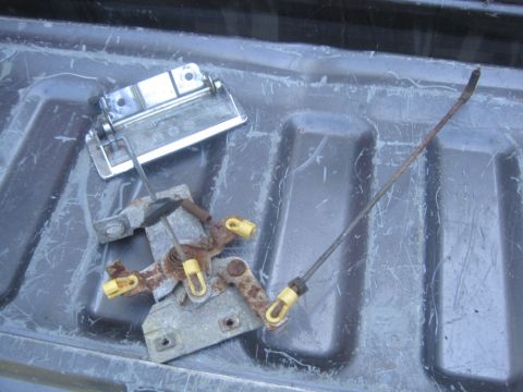 1993 Ford Bronco - Tailgate latch mechanism and handle assembly shown in a truck bed.
