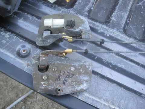 1993 Ford Bronco - These are two door latch mechanisms, likely for a vehicle, showing signs of wear and age.