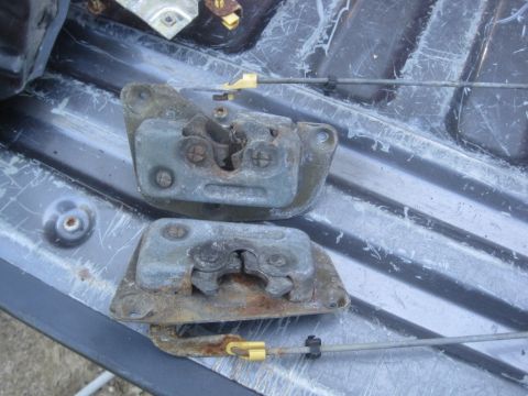 1993 Ford Bronco - Close-up of two used door latch assemblies, showing signs of wear and corrosion.