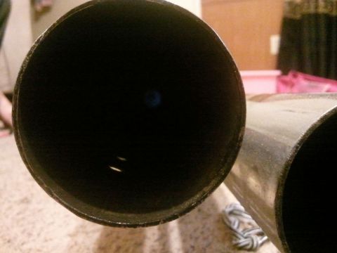 1995 Ford F-150 - Two exhaust pipes are shown, one with a matte black interior and the other with a polished metal exterior.