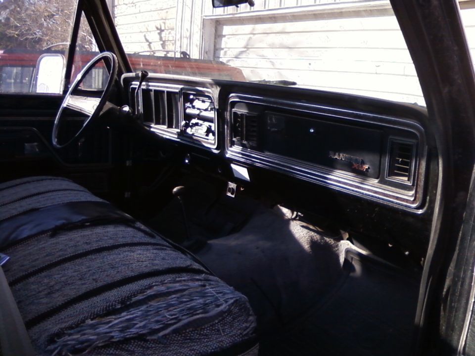 1977 Ford F-150 interior with striped seat and dashboard