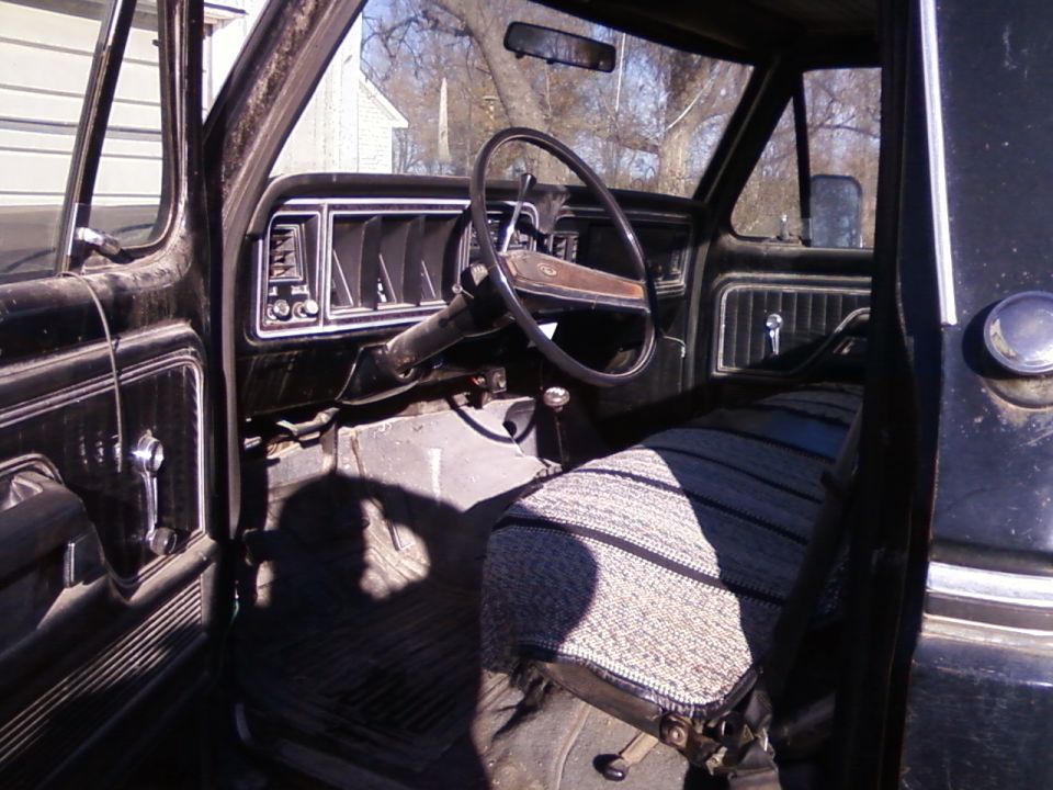 1977 Ford F-150 interior showing dashboard, steering wheel, and seat