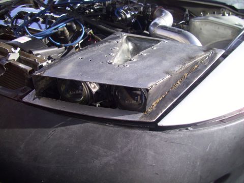 1995 Ford Probe - Custom hood scoop and headlights are visible in the engine bay of a car.