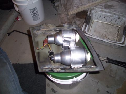 1995 Ford Probe - A pair of projector headlights are mounted on a metal bracket, likely for a custom vehicle modification.