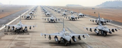 1989 Ford Bronco - A large formation of fighter jets is parked on a runway, ready for action.