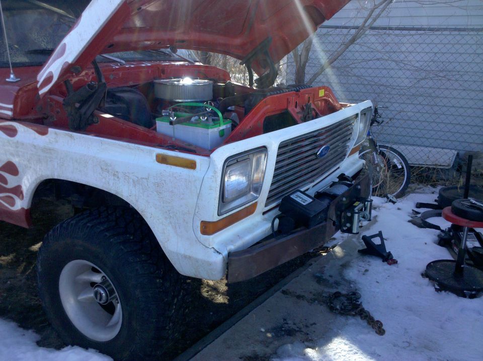 1979 Ford Bronco with hood open, showing engine and a winch mounted on the front bumper