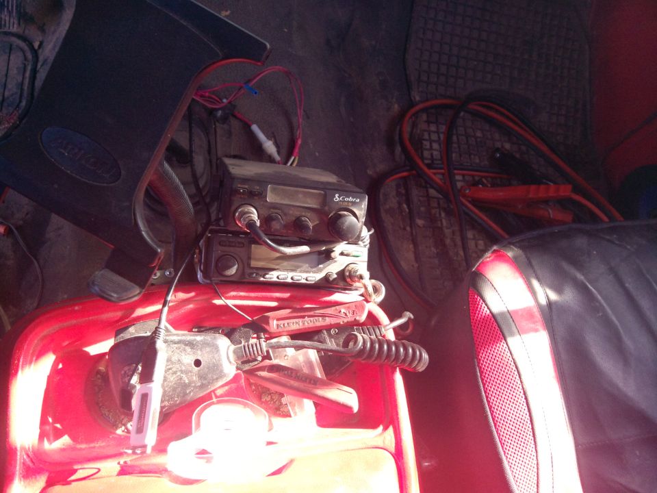 Interior view of CB radio and jumper cables in a vehicle