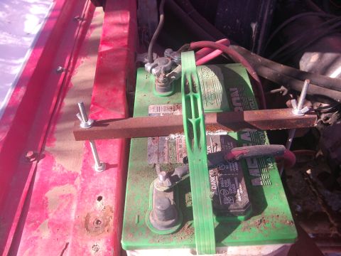 1979 Ford Bronco - The battery in this vehicle is secured with a makeshift metal bracket and bolts.