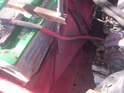 1979 Ford Bronco - Close-up view of a vehicle's engine bay, showing the battery and alternator components.
