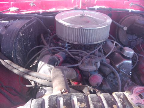 1979 Ford Bronco - Close-up view of a vehicle's engine bay, focusing on the air filter and associated components.