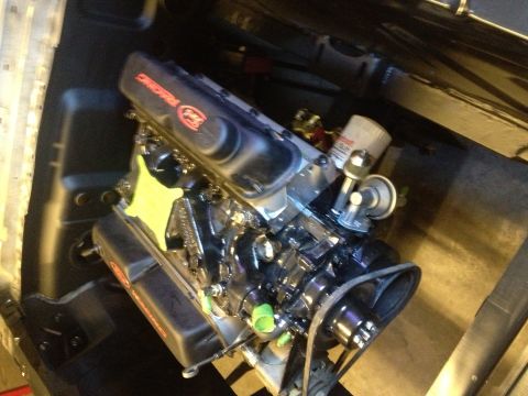 1965 Ford Mustang - Engine with black valve covers reading "Racing" and "Ford", oil filter visible.