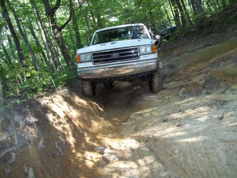 1990 Ford Bronco - This 1990 Ford Bronco tackles a challenging off-road course, demonstrating its capabilities.