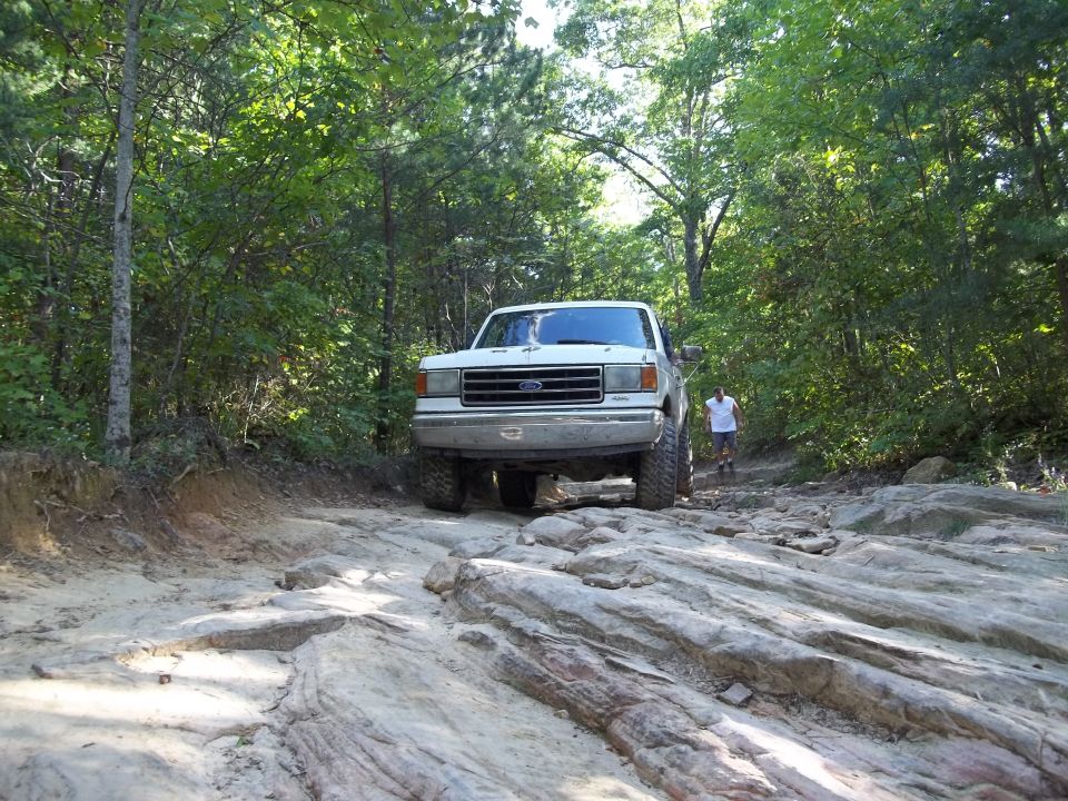 White 1990 Ford Bronco front view on rocky trail