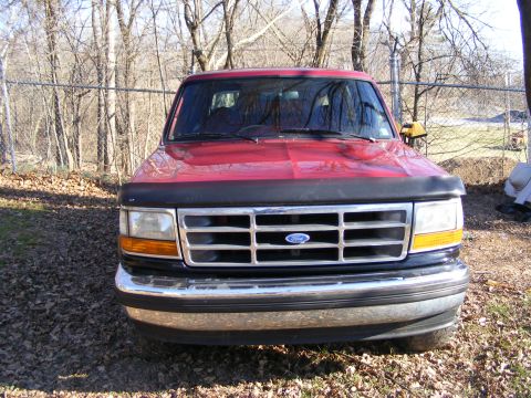 1995 Ford Bronco - Front view of a red 1995 Ford Bronco parked outdoors.