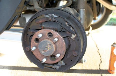 1976 Ford Ranchero - Close-up of a corroded drum brake assembly, showing brake shoes and springs.