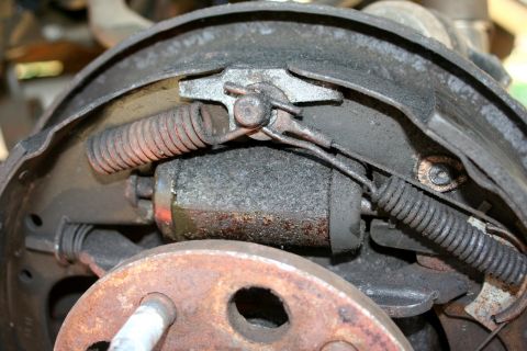 1976 Ford Ranchero - Close-up of a worn drum brake assembly, showing internal components and signs of rust.