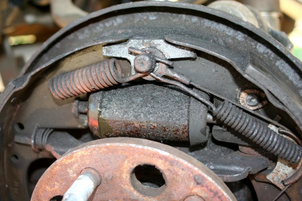 Rusty drum brake assembly with brake shoes, springs, and wheel cylinder