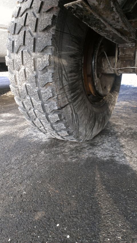 1995 Ford Bronco - Close-up view of a vehicle's tire and suspension components.