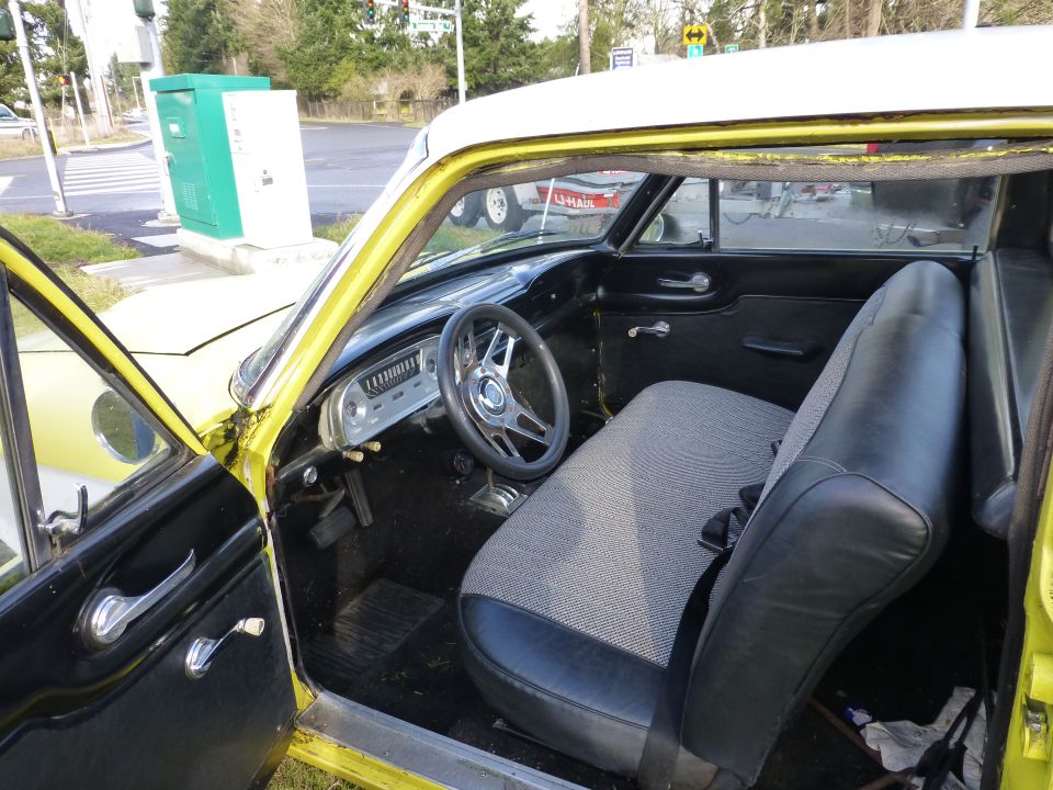 Interior of a 1961 Ford Ranchero, showing dashboard, steering wheel, and bench seat