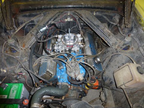 1961 Ford Ranchero - Engine bay of a 1961 Ford Ranchero, showing the V8 engine with aftermarket chrome valve covers and a Holley carburetor.