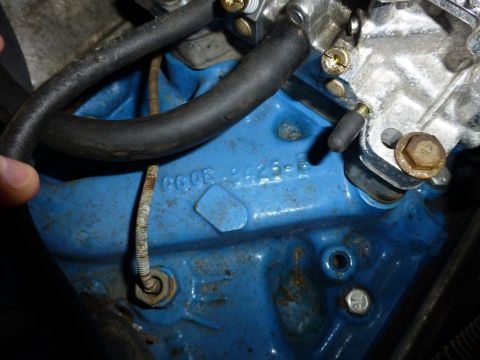 1961 Ford Ranchero - Close-up of a blue engine block showing stamped identification numbers.