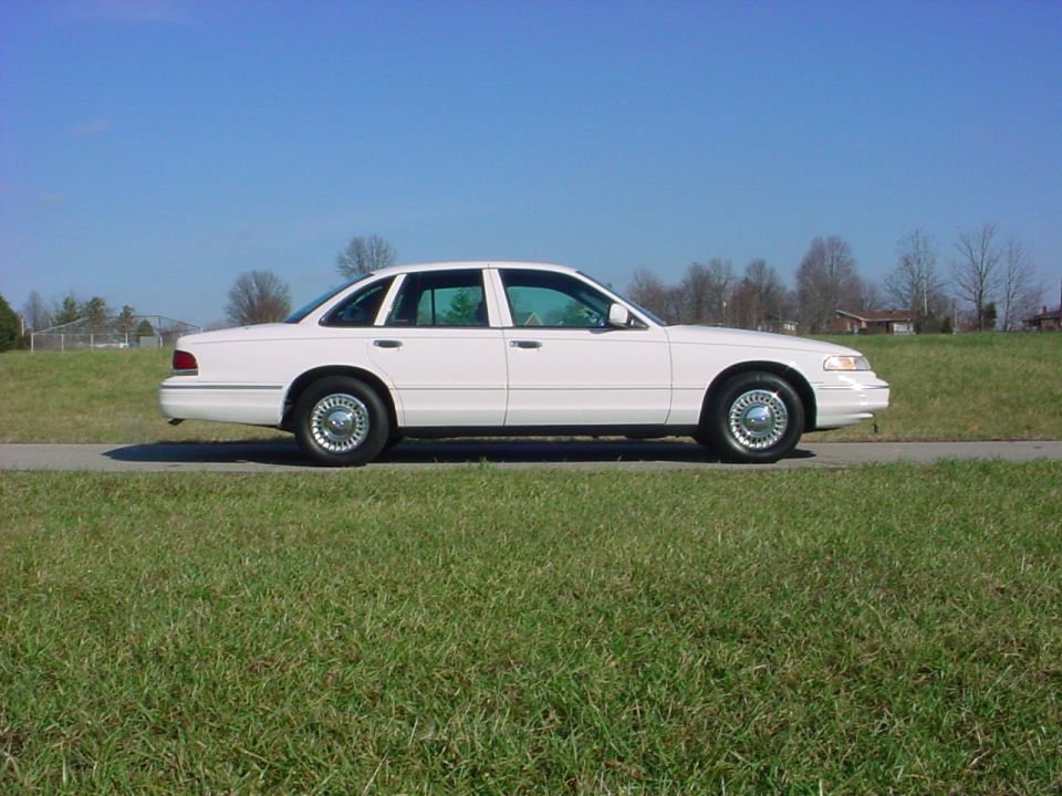 White 1999 Mercury Grand Marquis sedan, side view