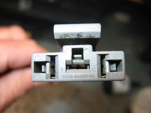 1992 Ford Bronco - Close-up of a gray electrical connector, possibly from a Ford vehicle, showing part number E53B-14489-OA.