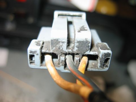 1992 Ford Bronco - Dusty electrical connector with wires, likely a vehicle part.