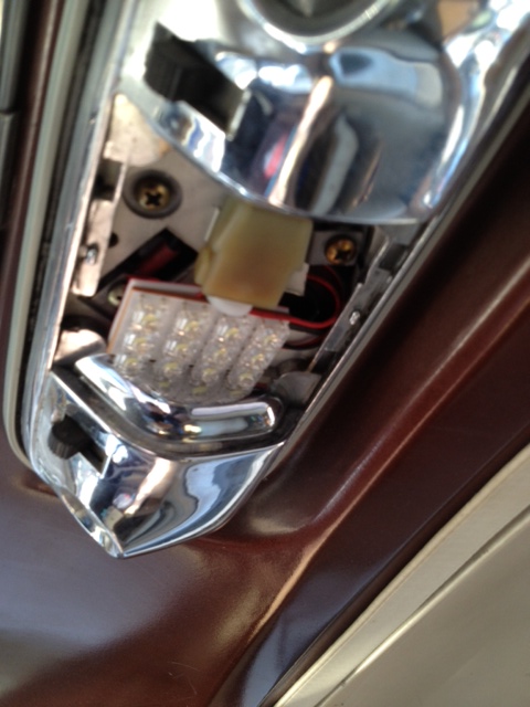 1979 Ford Bronco - Close-up of an aftermarket LED light fixture installed in a vehicle's interior trim panel.