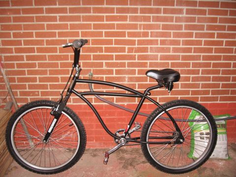 1994 Ford Bronco - A custom cruiser bicycle is shown against a brick wall, with a bag of fertilizer in the background.