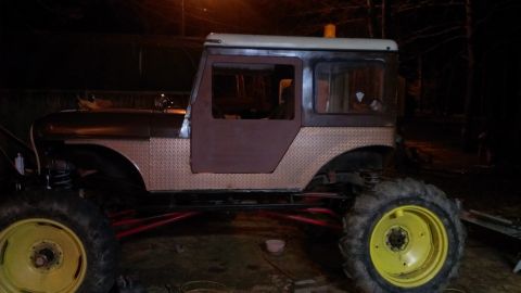 1978 Ford Bronco - Side view of a heavily modified vehicle with large tires and custom bodywork.