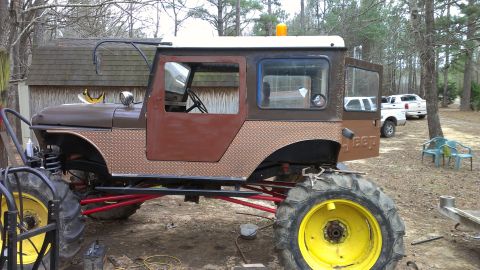 1978 Ford Bronco - This heavily modified Jeep CJ-5 features oversized tractor tires and a custom brown and white paint scheme.