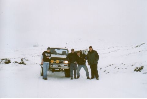 1996 Ford Bronco - Four men pose in front of a 1990 Nissan Pathfinder in a snowy, overcast environment.