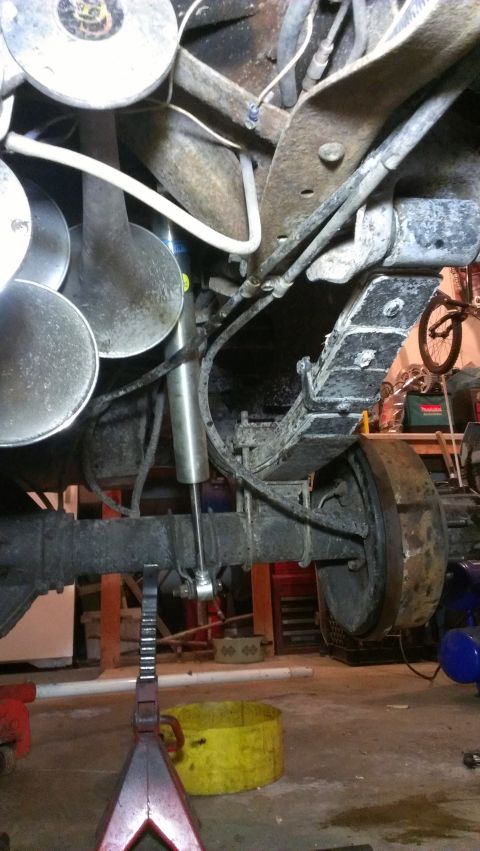 1995 Ford Bronco - Close-up view of a vehicle's rear axle and suspension system during maintenance.