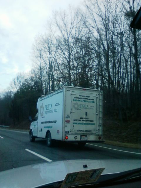 1971 Ford Ranchero - A white box truck with 'PEED PLUMBING, INC.' branding is seen from behind on a highway, surrounded by trees.