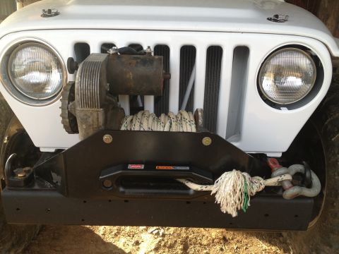 2000 Jeep TJ - Front view of a 2000 Jeep TJ showing the grille, headlights, and a winch assembly.