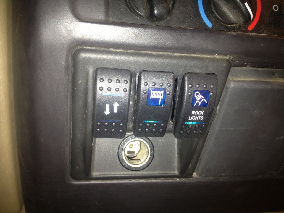 Auxiliary switches in a vehicle interior, labeled for winch, and rock lights
