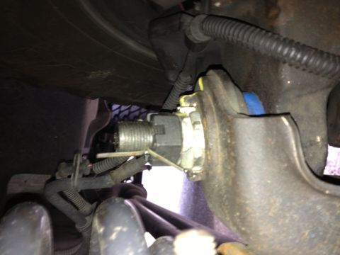 1993 Ford Bronco - Detail of a vehicle's suspension system, showing a nut and pin assembly.