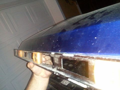 1994 Ford Bronco - Close-up of the front fender and hood of a blue 1994 Ford Bronco, showing the marker light housing.