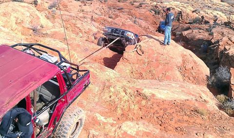 1994 Ford Bronco - Off-road vehicles navigate challenging rocky terrain, with one vehicle assisting another's recovery.