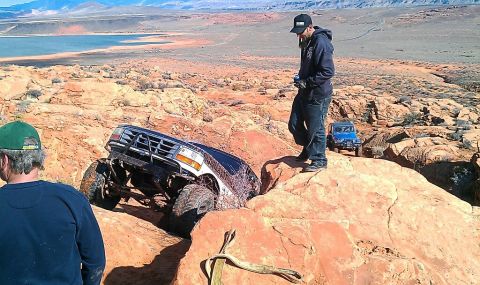 1994 Ford Bronco - An off-road vehicle navigates a challenging rocky trail with another vehicle following.