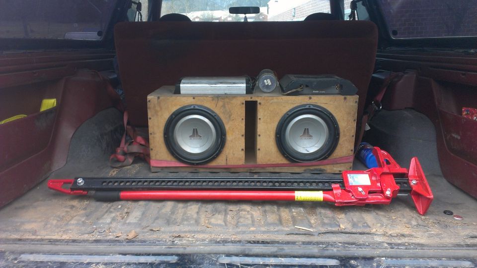 Interior cargo area with dual subwoofers and a red hi-lift jack