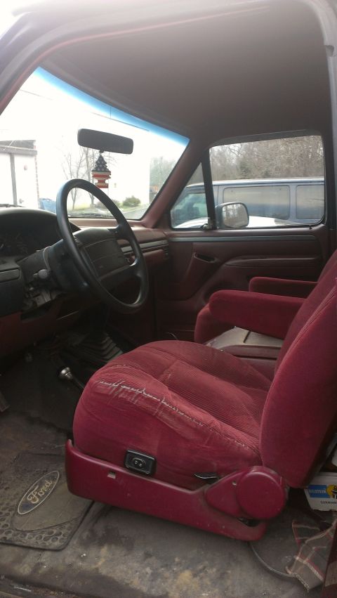 1995 Ford Bronco - The interior of a Ford truck is shown, with a focus on the driver's seat and steering wheel.