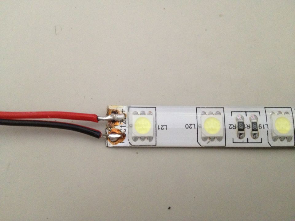 LED strip light with red and black wires soldered to connection points. Text 'L21', 'L20', 'R2', 'L19' visible